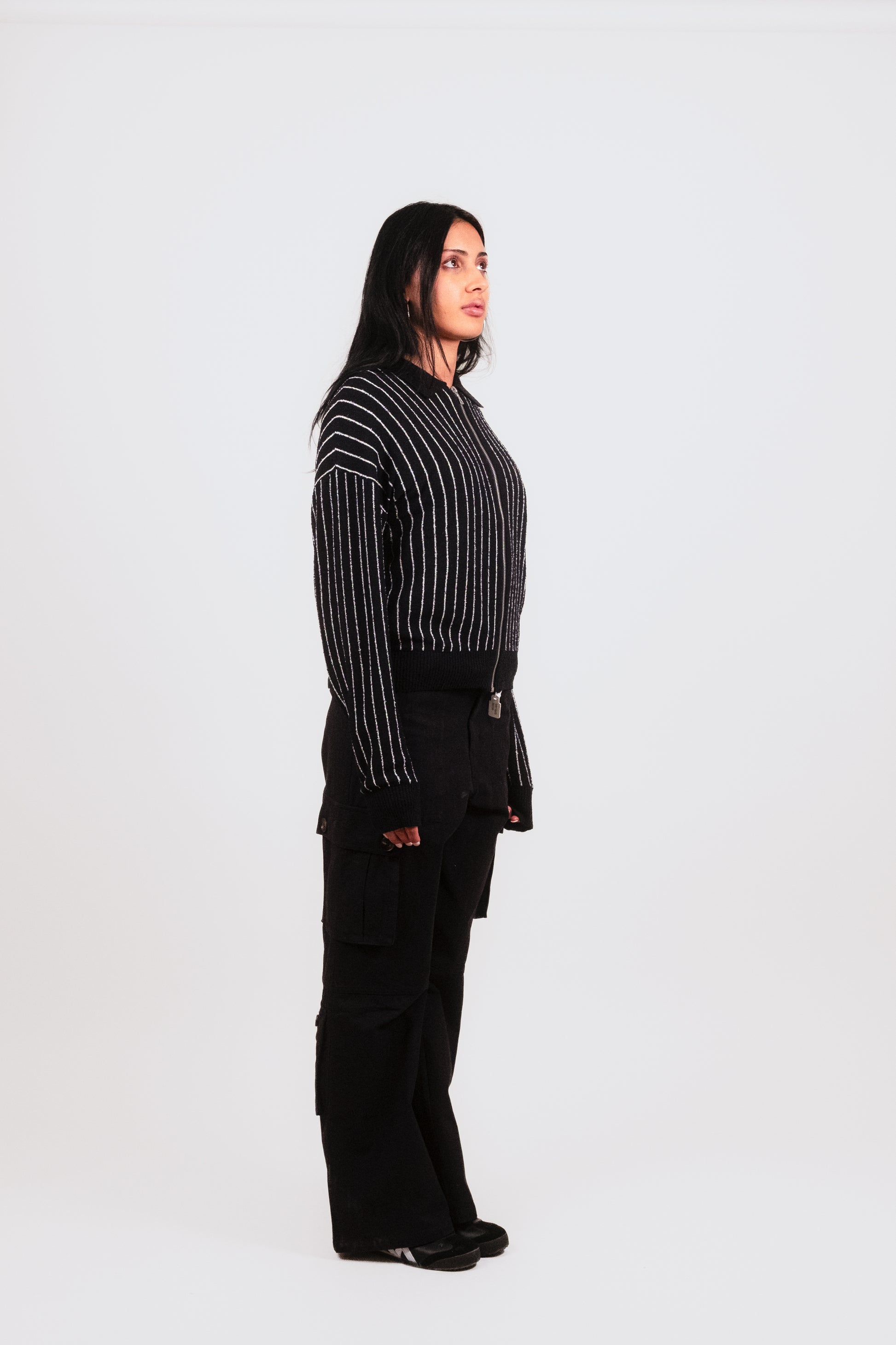 Alternate 1/4 angle of Anisa in Six Pocket Flare Cargo, capturing the tailored flare leg, cargo pocket arrangement, and streetwear luxury craftsmanship.