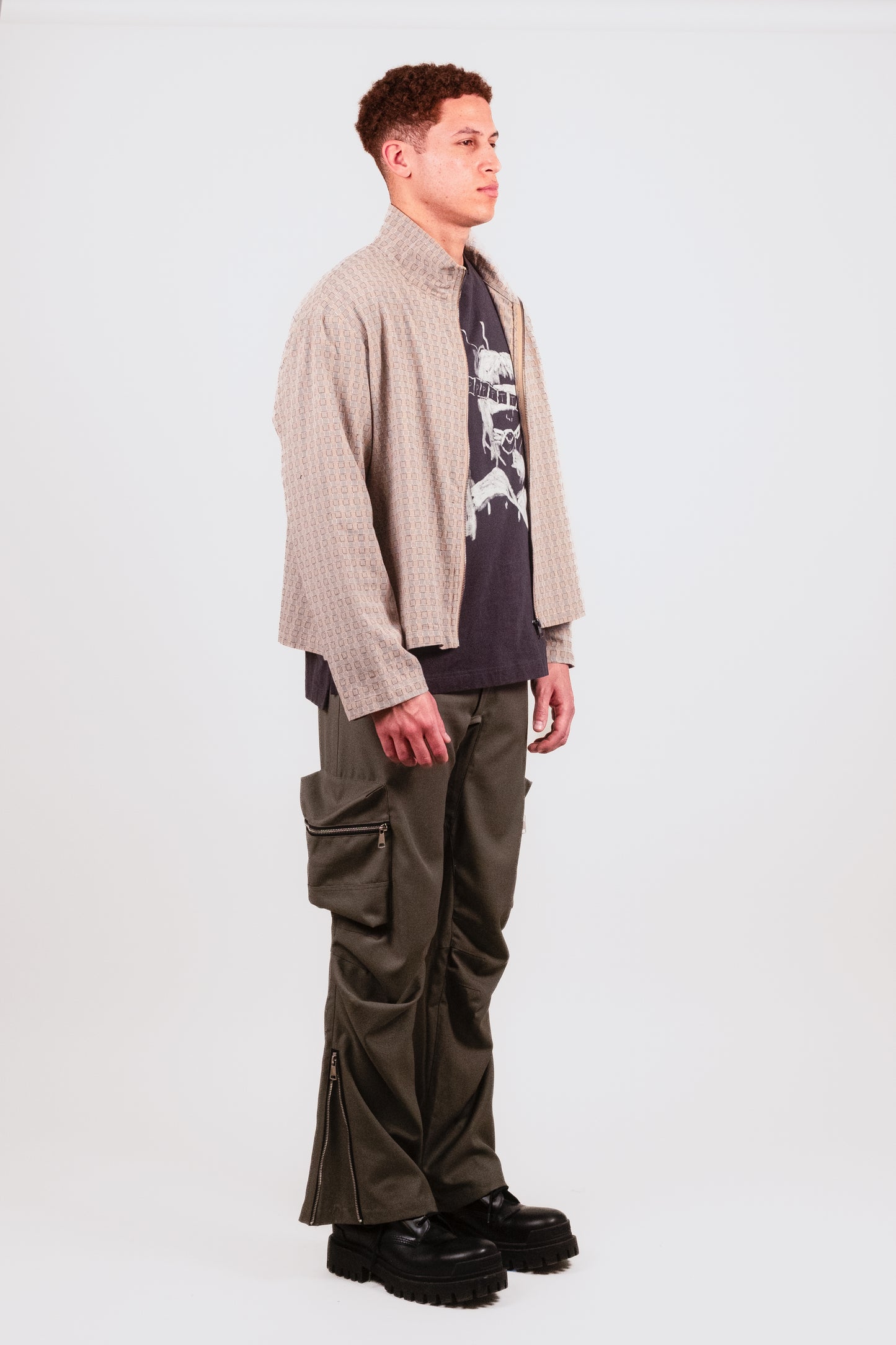 Male model alt 1/4 angle in Technicalist Cargo — structured utility streetwear trousers in light olive grey wool - and  Smart Zip — smart casual pastel zip-up with boxy cut and elevated woven construction perfect for the summer