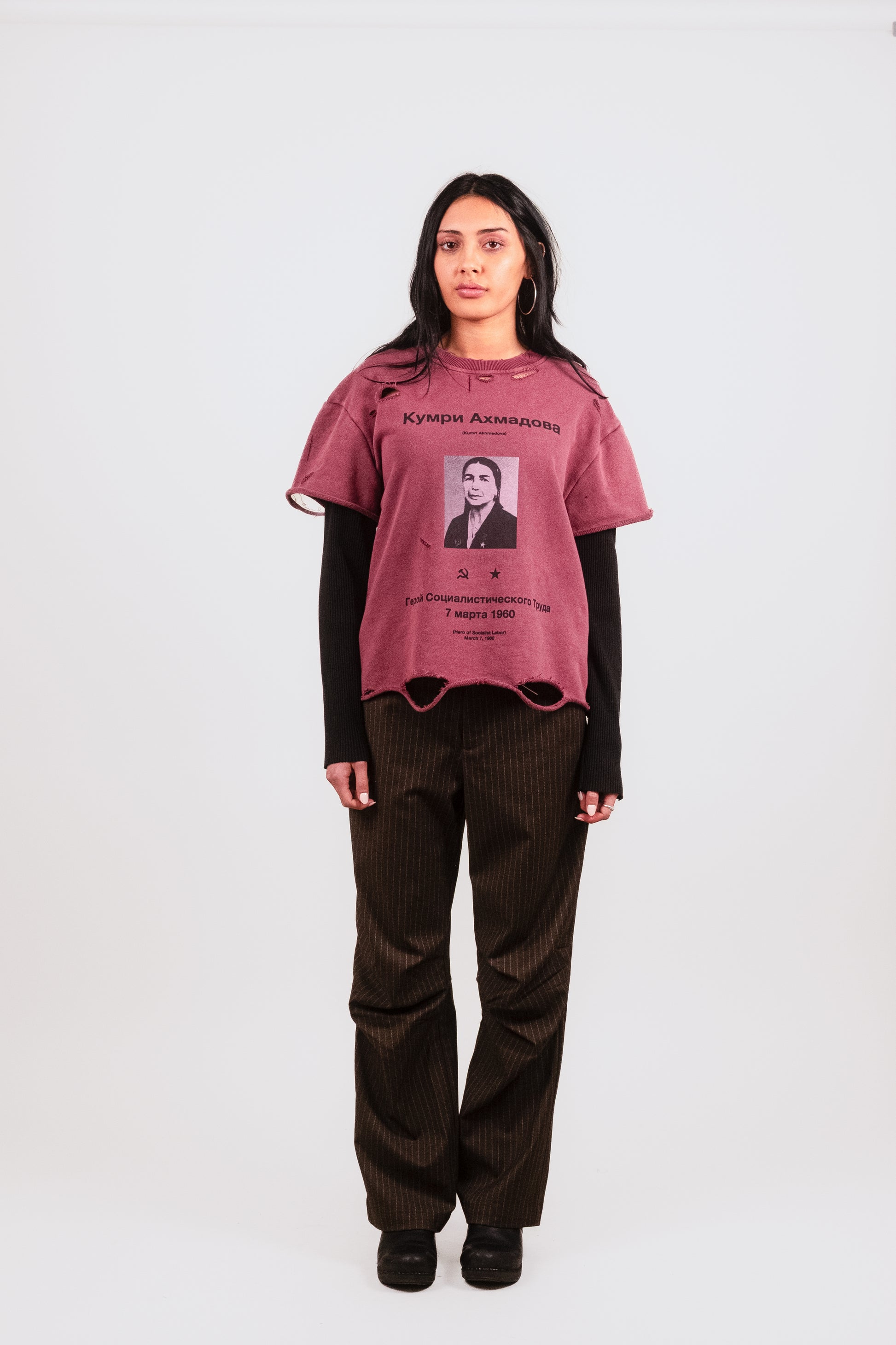 Anisa wears the Socialist Hero Thermal Long Sleeve front-facing, highlighting the bold socialist labor graphic, distressed raw hem crewneck, and layered long sleeve design in avant-garde streetwear.
