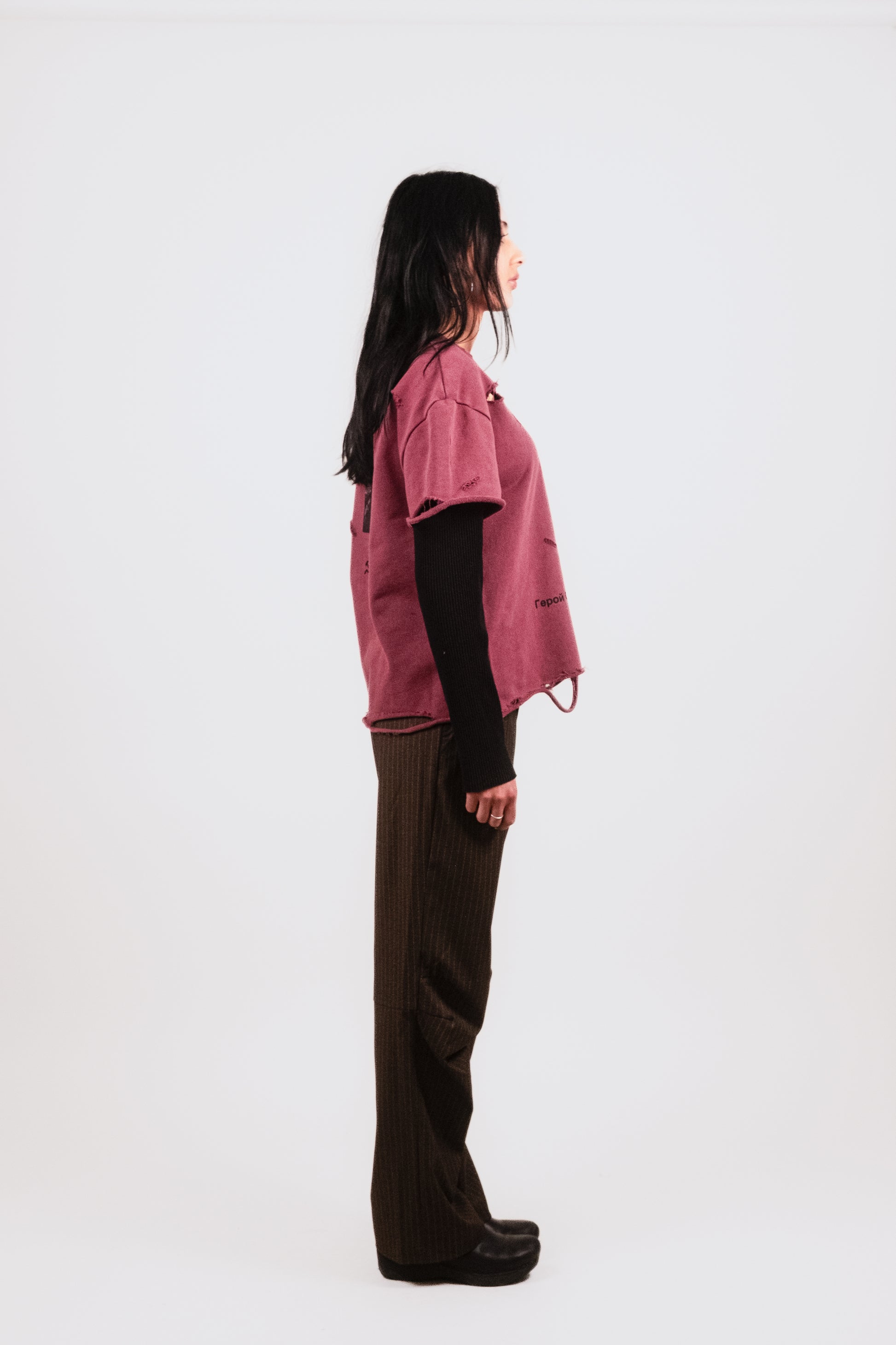 Female model alternate profile in Tucked Trouser — subtle military cues in luxe compressed wool pinstripe