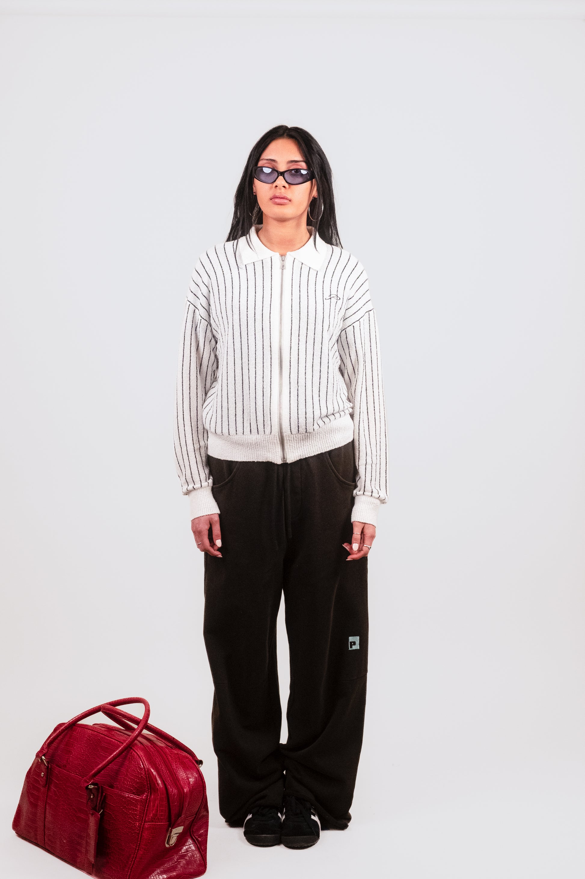 Alternate front angle of Anisa in the Posh Full Zip, capturing the signature embroidered detail, luxe knit texture, and tailored menswear-inspired silhouette.