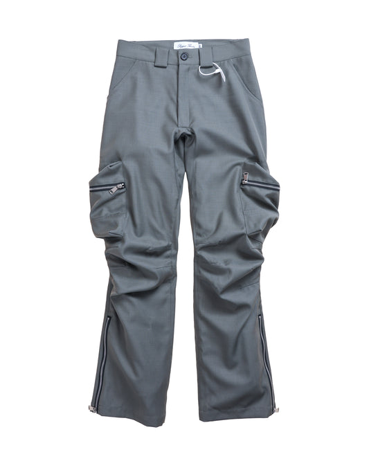 Flat lay front of Puppet Theater Technicalist Cargo — light olive grey wool cargo trousers with sculptural darts and 3D side pockets